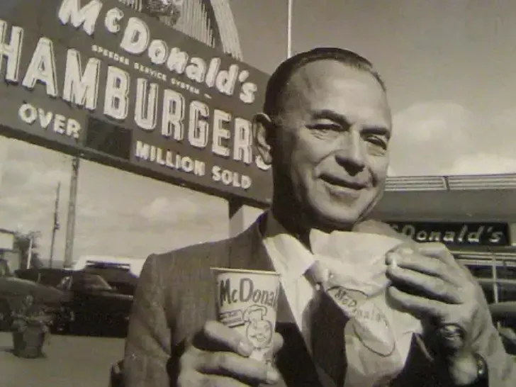 Mc Donalds Founder Ray Kroc Standing Next to Hamburger Franchise